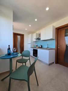 a kitchen with a table and two chairs and a table at Verso Maison in Gragnano
