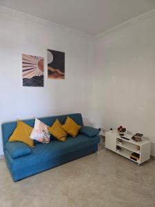 a living room with a blue couch and a table at Verso Maison in Gragnano