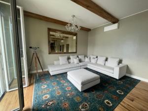 a living room with white couches and a rug at Luxury in Lake Como in a 5 bed lake front home in Valmadrera