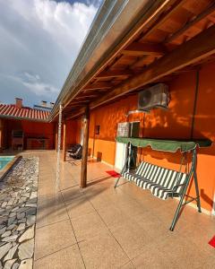 a patio with a hammock on the side of a house at Espaço R&R 2 in São Roque