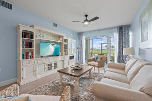 a living room with a couch and a tv at Golf Condo Views With Resort Pool and Amenities in Naples