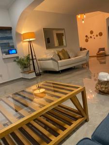 a living room with a couch and a glass table at וילה בר בוטיק אילת in Eilat