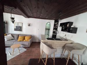 a kitchen and living room with a couch and a table at Динова Къща in Bozhentsi