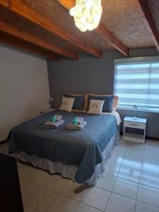 a bedroom with a bed with towels on it at Departamento Naim in Ushuaia