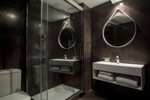 a bathroom with a shower and a sink and mirror at Aparthotel Allada 3* in Barcelona +9 photos
