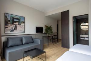 a living room with a couch and a table at Aparthotel Allada 3* in Barcelona