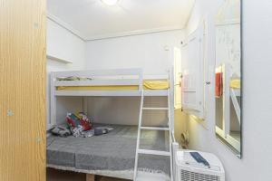 a room with two bunk beds and a ladder at CASA Maria do ceu orihuella costa alicante in Orihuela Costa +3 photos