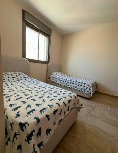 a bedroom with two beds and a window at Splendid Penthouse Duplex 6 Rooms ! in Bet Shemesh