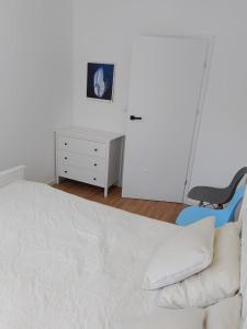 a bedroom with a bed and a desk and a chair at Jeziorna Residence Borne Sulinowo in Borne Sulinowo