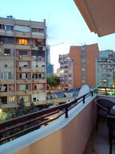 a balcony with a view of a city with buildings at Golden Apartment in Tirana