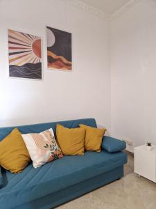 a blue couch with pillows on it in a living room at Verso Maison in Gragnano +60 photos