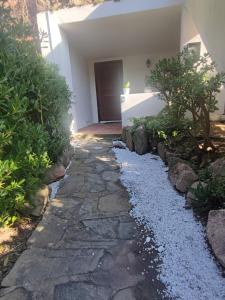 a stone walkway in front of a house at Emadi House Porto Rotondo in Porto Rotondo