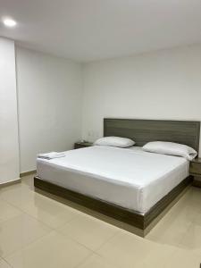 a bedroom with a large bed in a room at Hotel Brisas in Tierra Bomba +11 photos