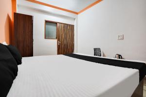 Postel nebo postele na pokoji v ubytování Hotel O Harmony