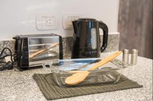 a counter with a bowl and a toaster and a wooden spoon at Apart JH Belgrano Nordic in Buenos Aires