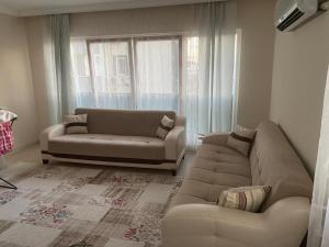 Una sala de estar con dos sofás y una ventana. en Smart Apartment, en Antalya
