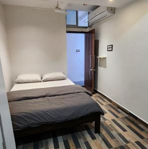 a bedroom with a bed in a room with a window at Stylish comfy Room near Airport in Chennai