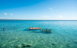 a dock in the middle of a large body of water at Azul Nomeolvides Bacalar - Lagoon Front in Bacalar +46 photos
