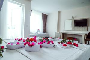 a table with pink flowers on top of it at Dream Town Hotel&Restaurant in Kemer