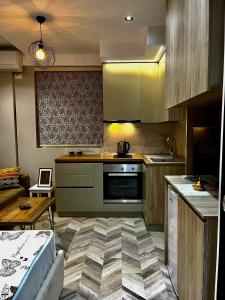a kitchen with a stove and a counter top at Family Adventure at Pazar in Tirana