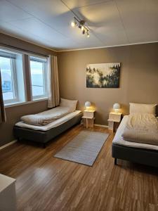 Postel nebo postele na pokoji v ubytování Gultoppen Tromsø