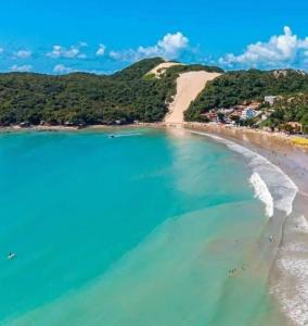 an aerial view of a beach with turquoise water at Flat vista Mar -conforto e estilo em Ponta Negra-Natal in Natal +3 photos