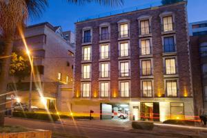 a large brick building on a city street at night at Central Apartamentos Bogotá in Bogotá