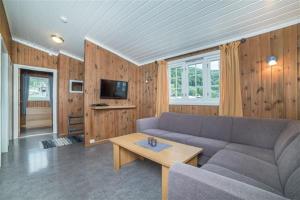 a living room with a couch and a table at Pluscamp Mageli in Bjørge
