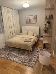 a bedroom with a bed and a rug at Central London Studio Apartment in London