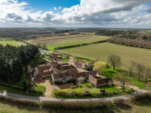 an aerial view of a house in a field at Tern Place in Kelling