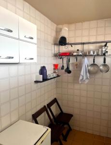 a kitchen with white cabinets and a table and chairs at Apartamento Vista-Mar in Maceió