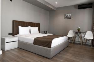 a bedroom with a large bed and a table at Old Baku Boutique Hotel in Baku