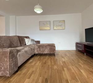 a living room with a couch and a television at Moon night in Niš