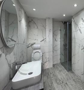 a bathroom with a toilet and a sink and a mirror at Moon night in Niš