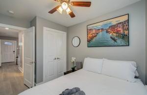 a bedroom with a white bed and a ceiling fan at 2-Bedroom Townhouse in Houston in Houston