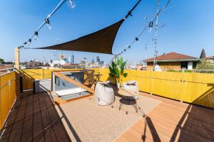 a patio with an umbrella and a chair on a deck at BRERA LittleSuite DuomoView in Milan