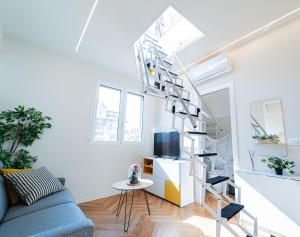 a white living room with a spiral staircase at BRERA LittleSuite DuomoView in Milan