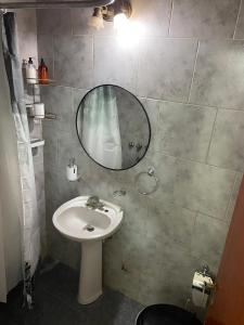 a bathroom with a sink and a mirror at Estudio Alma in Miramar
