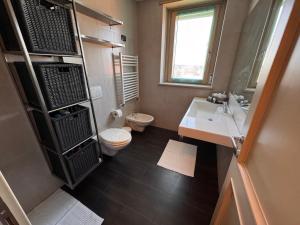 a bathroom with a toilet and a sink at Little Luxury Penthouse in Acilia +32 photos
