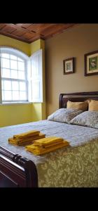 a bedroom with a bed with two robes on it at Sé House View in Angra do Heroísmo