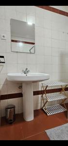 a bathroom with a white sink and a mirror at Sé House View in Angra do Heroísmo