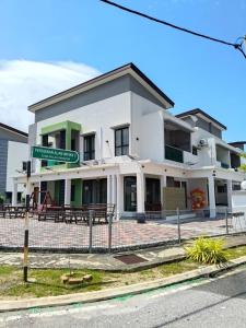 ein weißes Gebäude mit einem Straßenschild davor in der Unterkunft Pangkor L30 88 Corner villa House in Pulau Pangkor