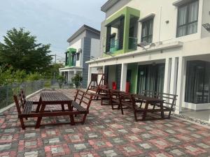 a group of benches sitting outside of a building at Pangkor L30 88 Corner villa House in Pangkor