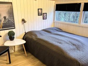 a bedroom with a bed and a table and a window at Luxury Spa Retreat on Als - By Traum Ferienwohnungen in Sarup