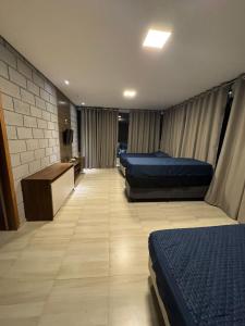 a hospital room with two beds and a desk at Chácara de alto padrão in Água Boa +47 photos