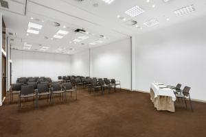 an empty room with chairs and a white wall at Kimpton Atlantico Algarve by IHG in Albufeira