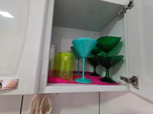 a cabinet with two glass vases on a shelf at Casa 2 quartos 2 banheiros 5 min centro 15 cataratas in Foz do Iguaçu +29 photos