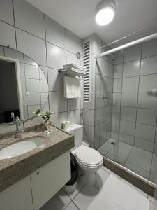 a bathroom with a toilet and a sink and a shower at Gran Lençóis Flat Residence in Barreirinhas