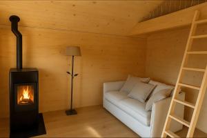 a living room with a couch and a wood stove at Les Mayens d'Adrien in Mase