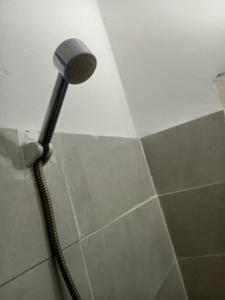 a shower with a shower head in a bathroom at Saidia palace in Saïdia +4 photos